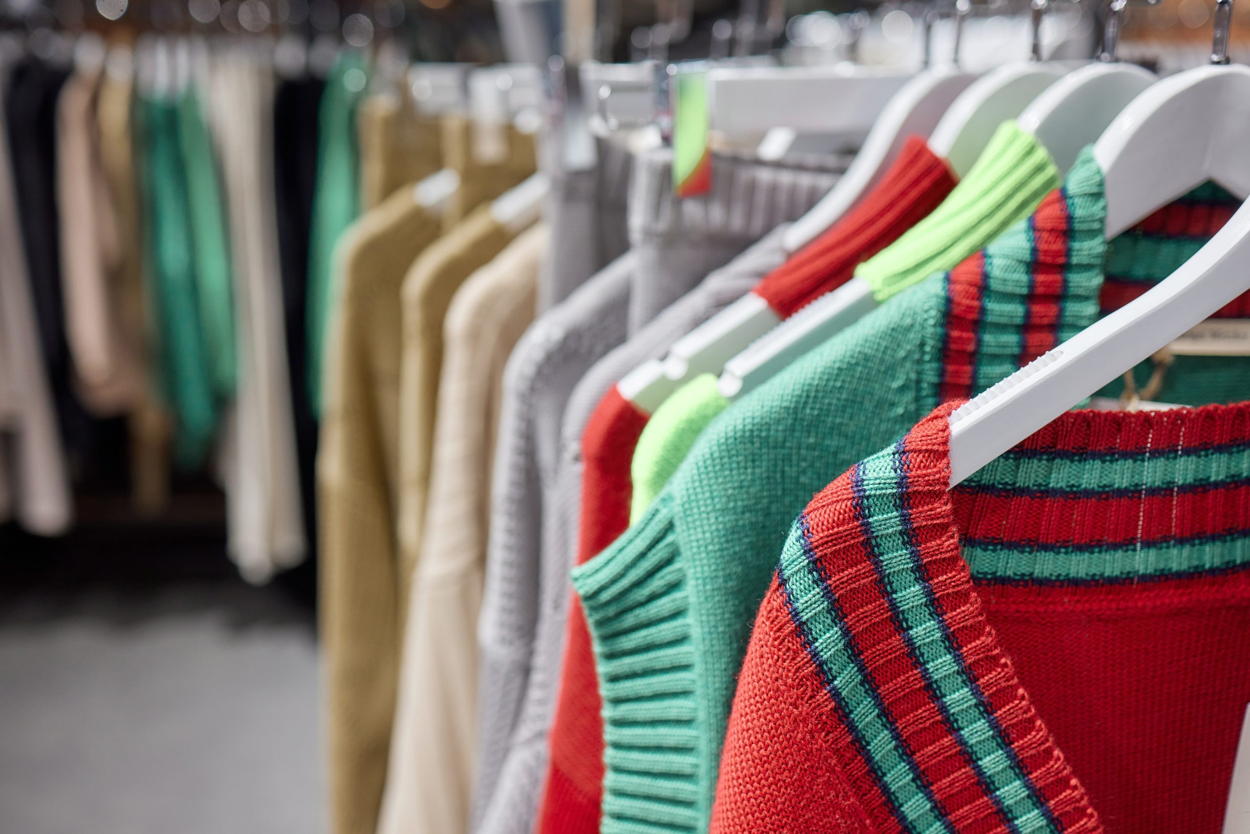 Fashion clothes on clothing rack, Bright colorful cotton shirts on hanger in boutique shop